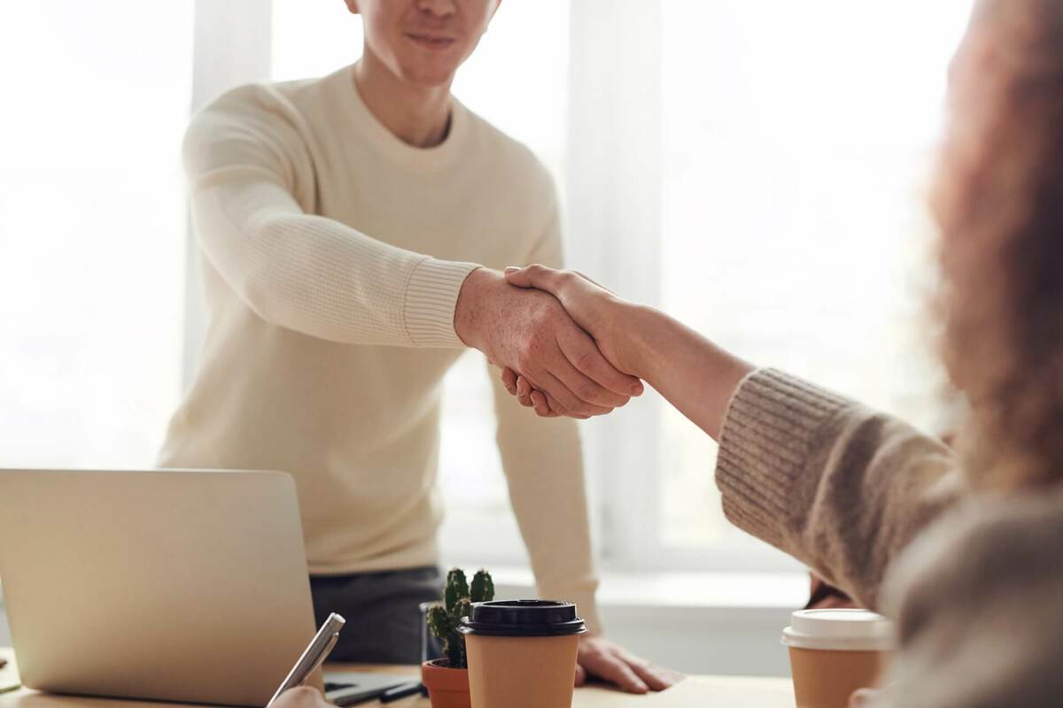 People shaking hands after a successful business meeting in an office setting